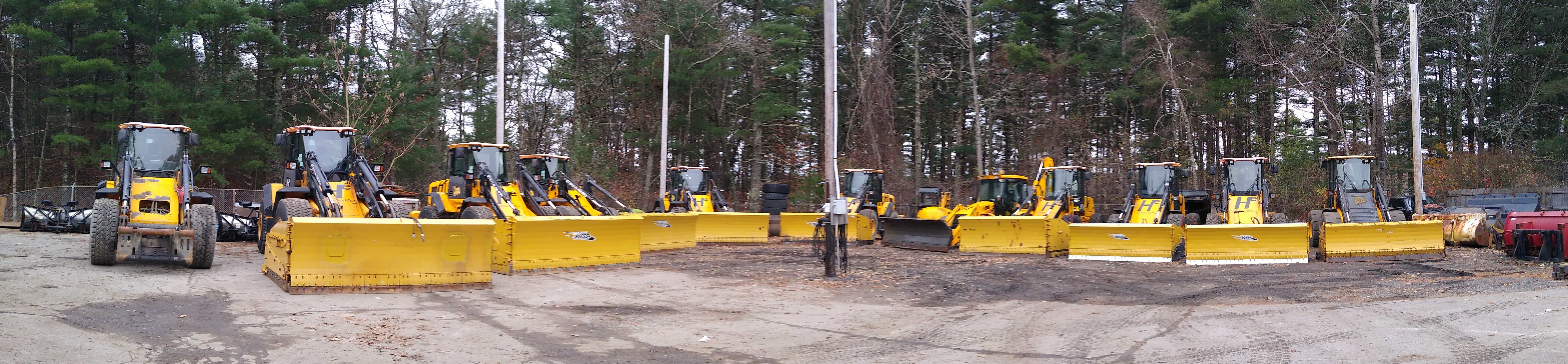 Skid steer plowing sidewalk