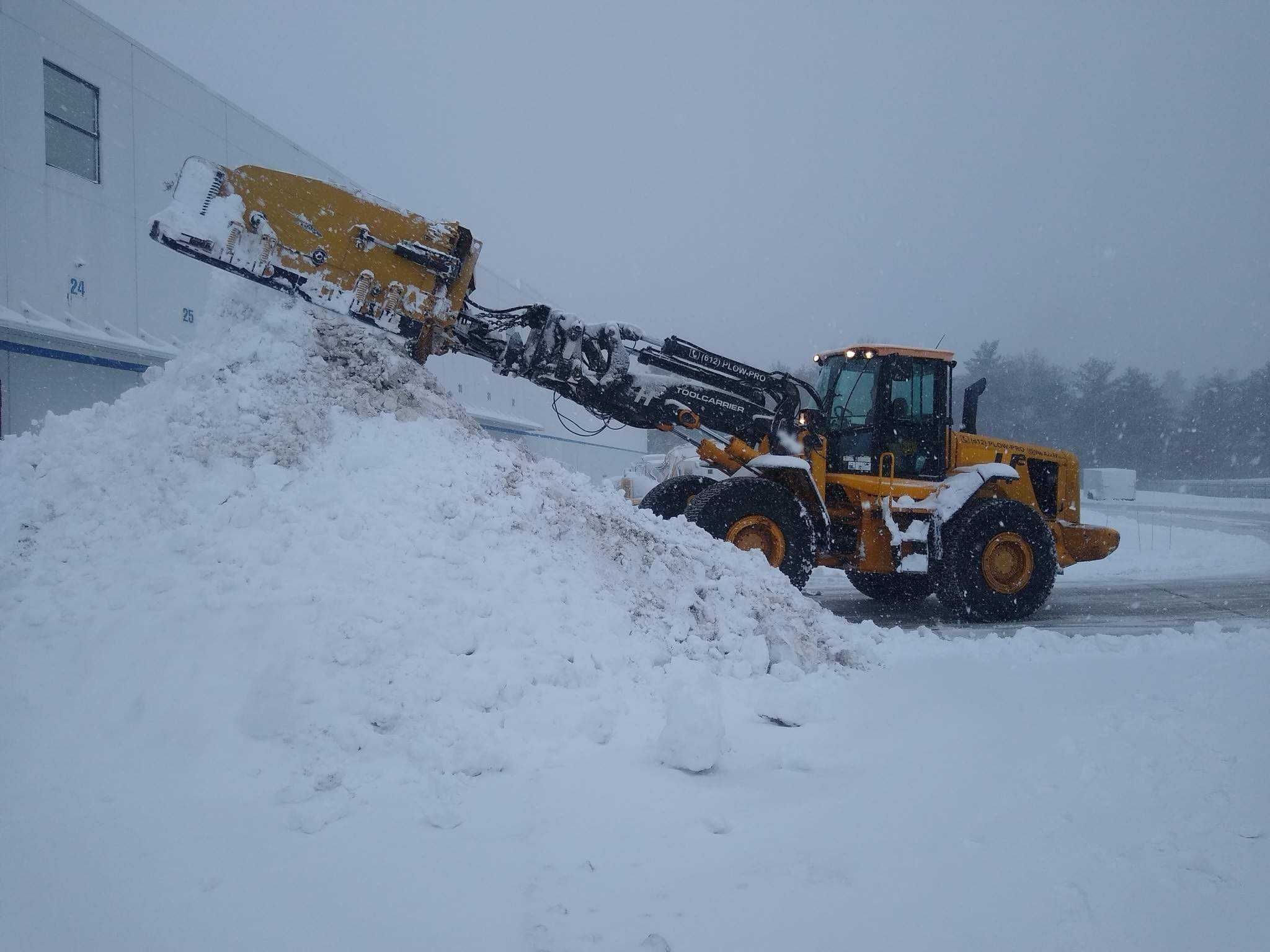 Hunter Environmental Front End Loader moving snow