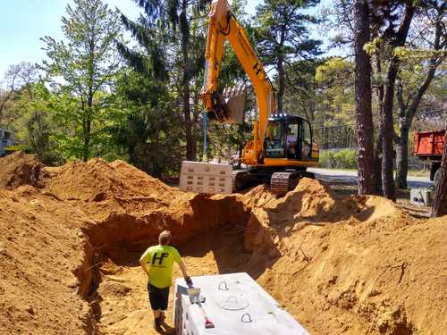 An excavator installing a septic system