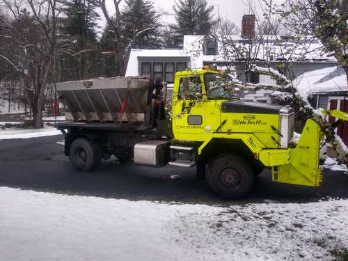 A truck sanding a road