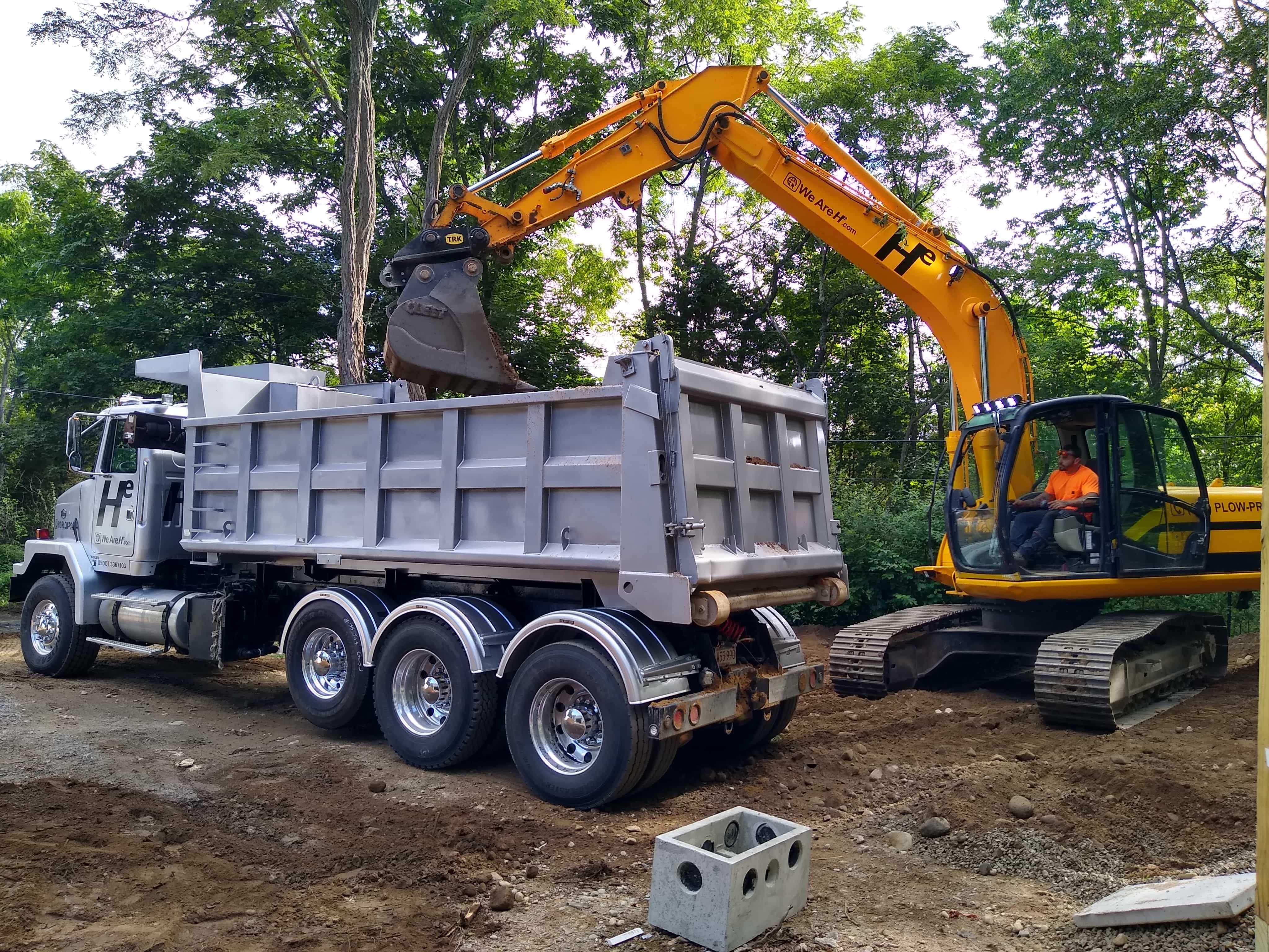 Hunter Environmental Dump truck working with excavator